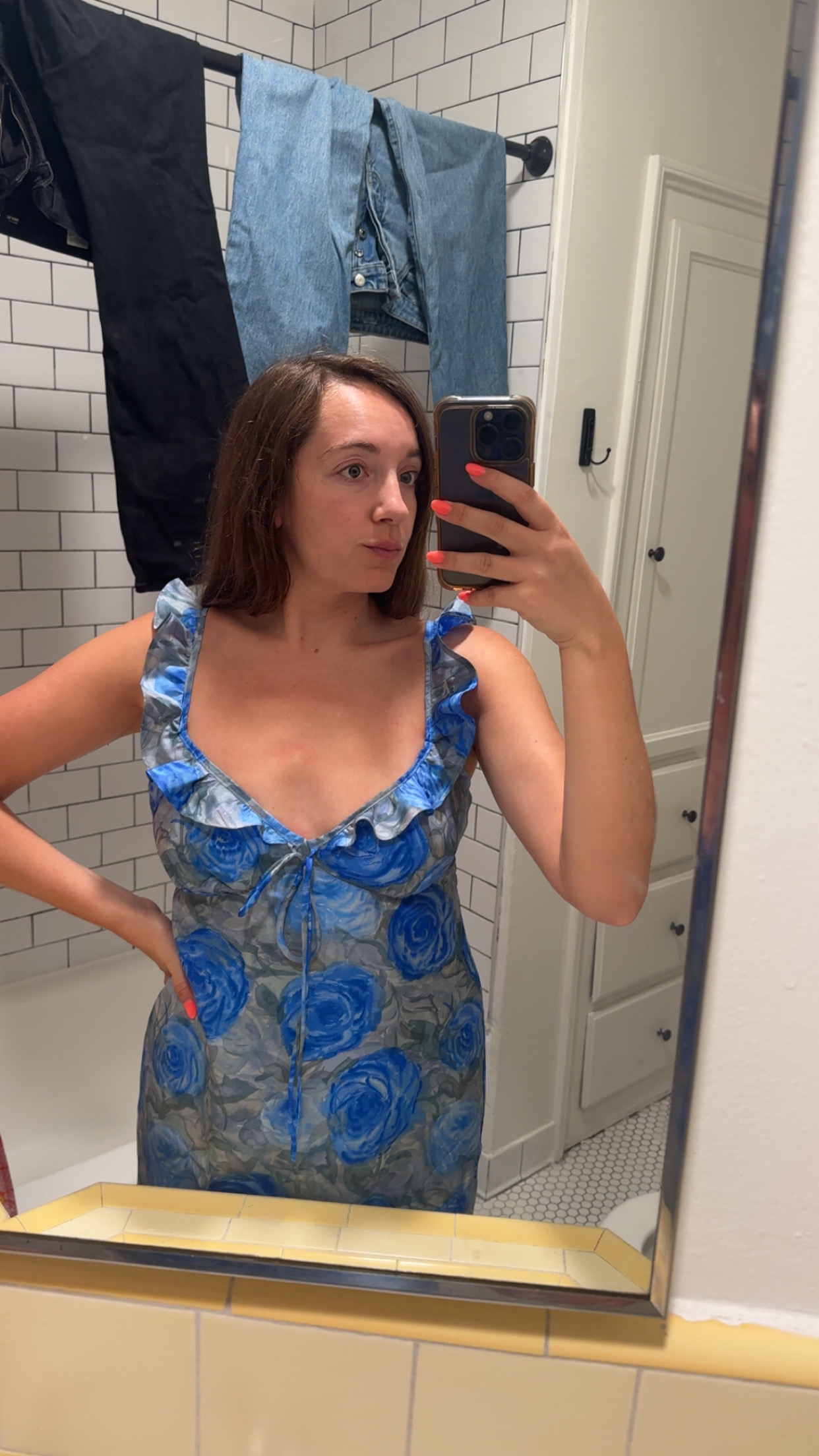 Close-up mirror photo of the finished flounce neckline and front tie detail on the Nelly Dress